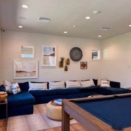 a clubroom with a couch and a pool table