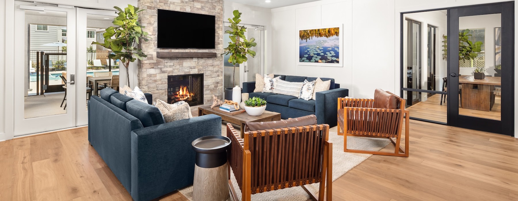 a clubroom with a tv, couches and chairs