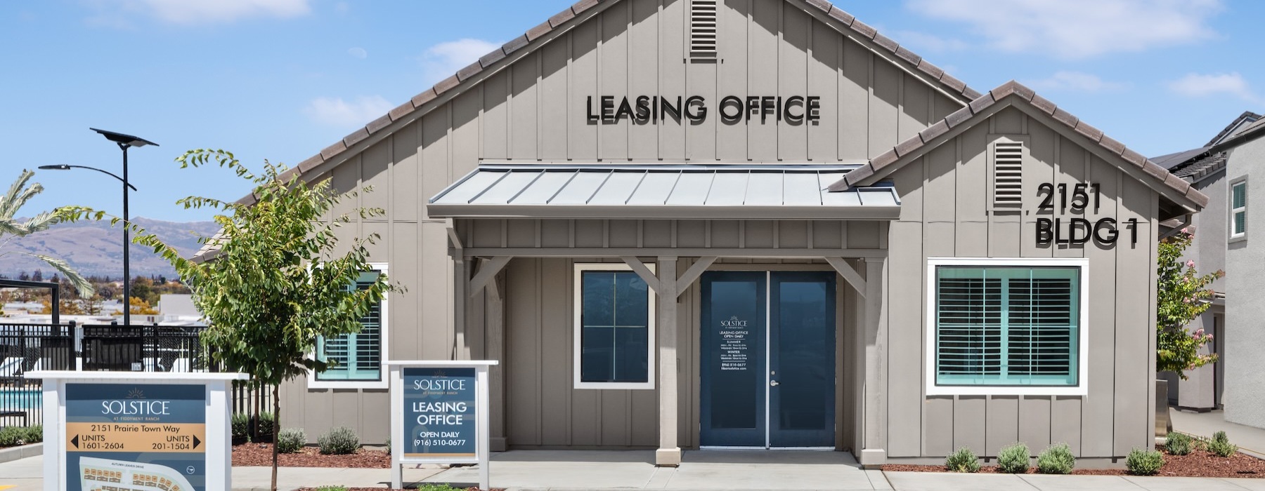a leasing office with a parking lot