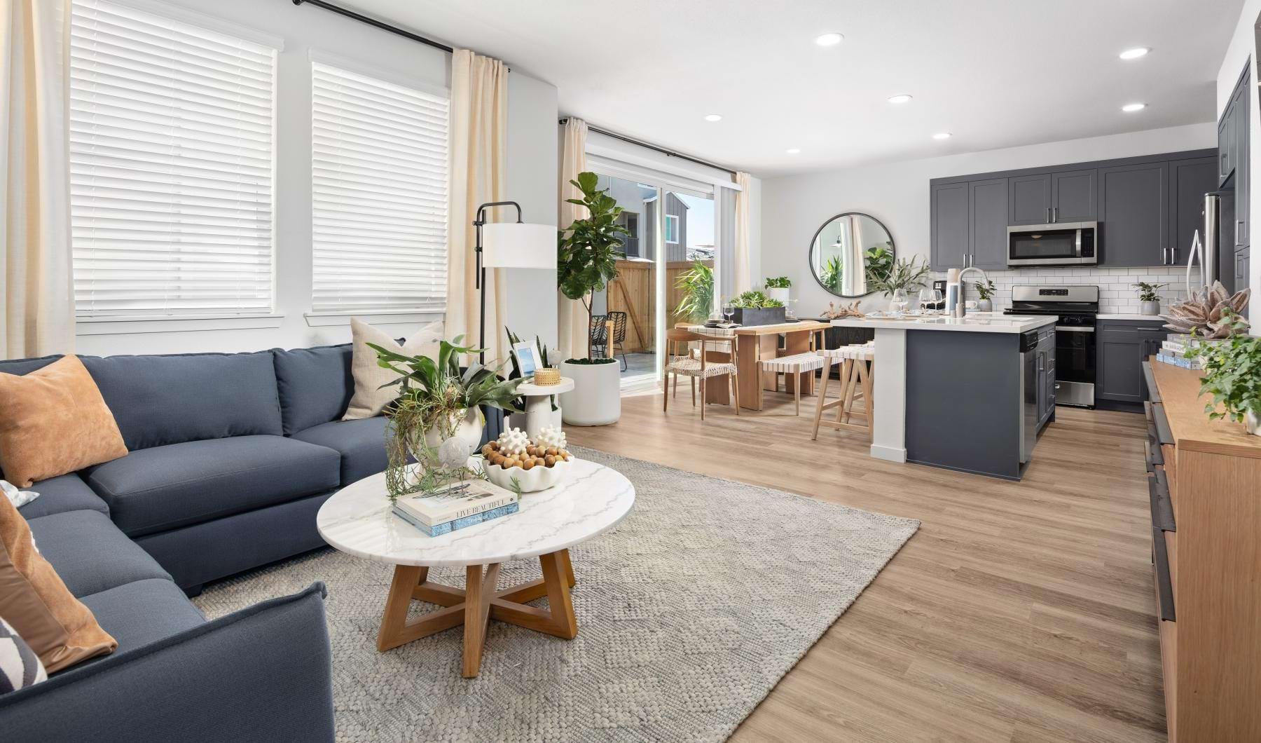 a living room with a couch, coffee table and rug